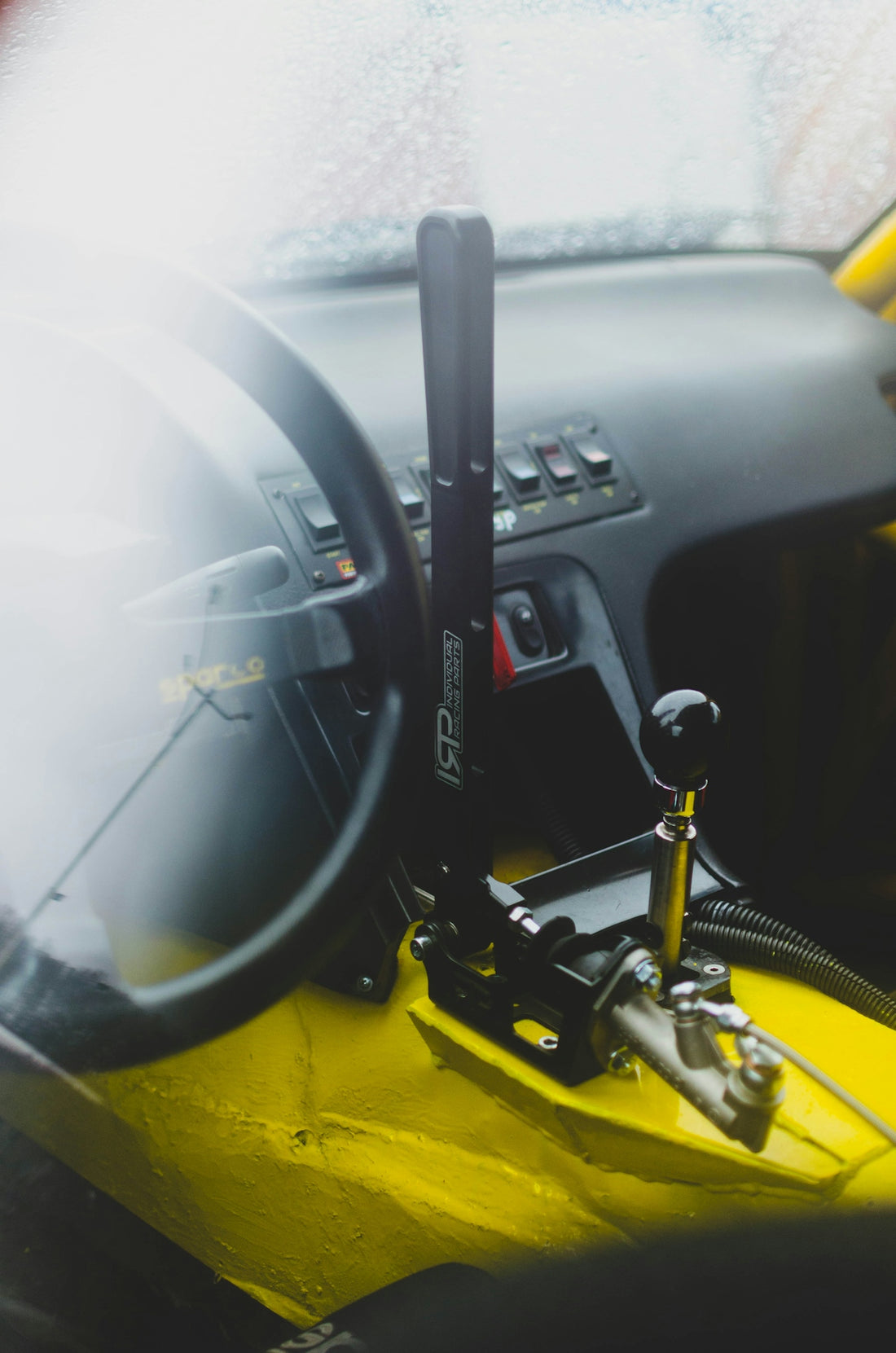 black car steering wheel and yellow car seat