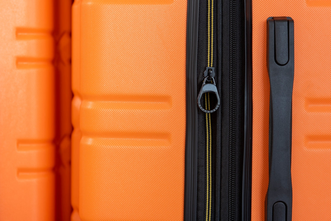 an orange piece of luggage with a black handle