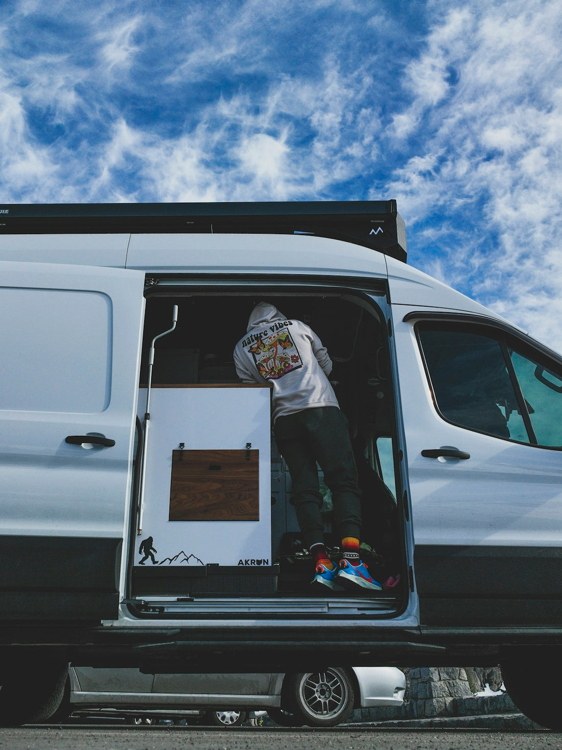a man standing in the back of a white van