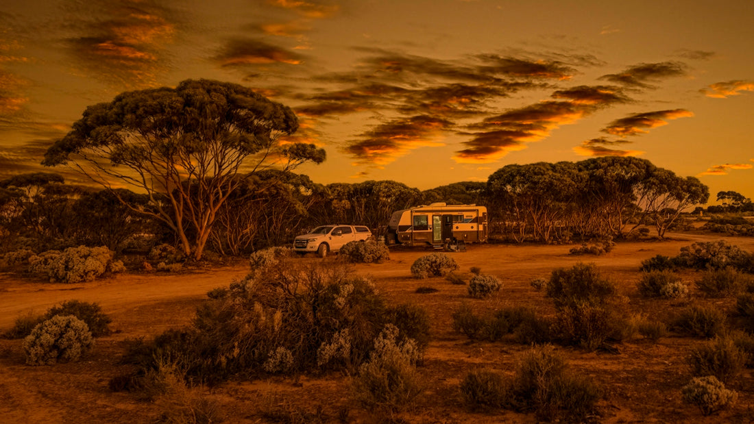 a couple of vehicles parked on a dirt road