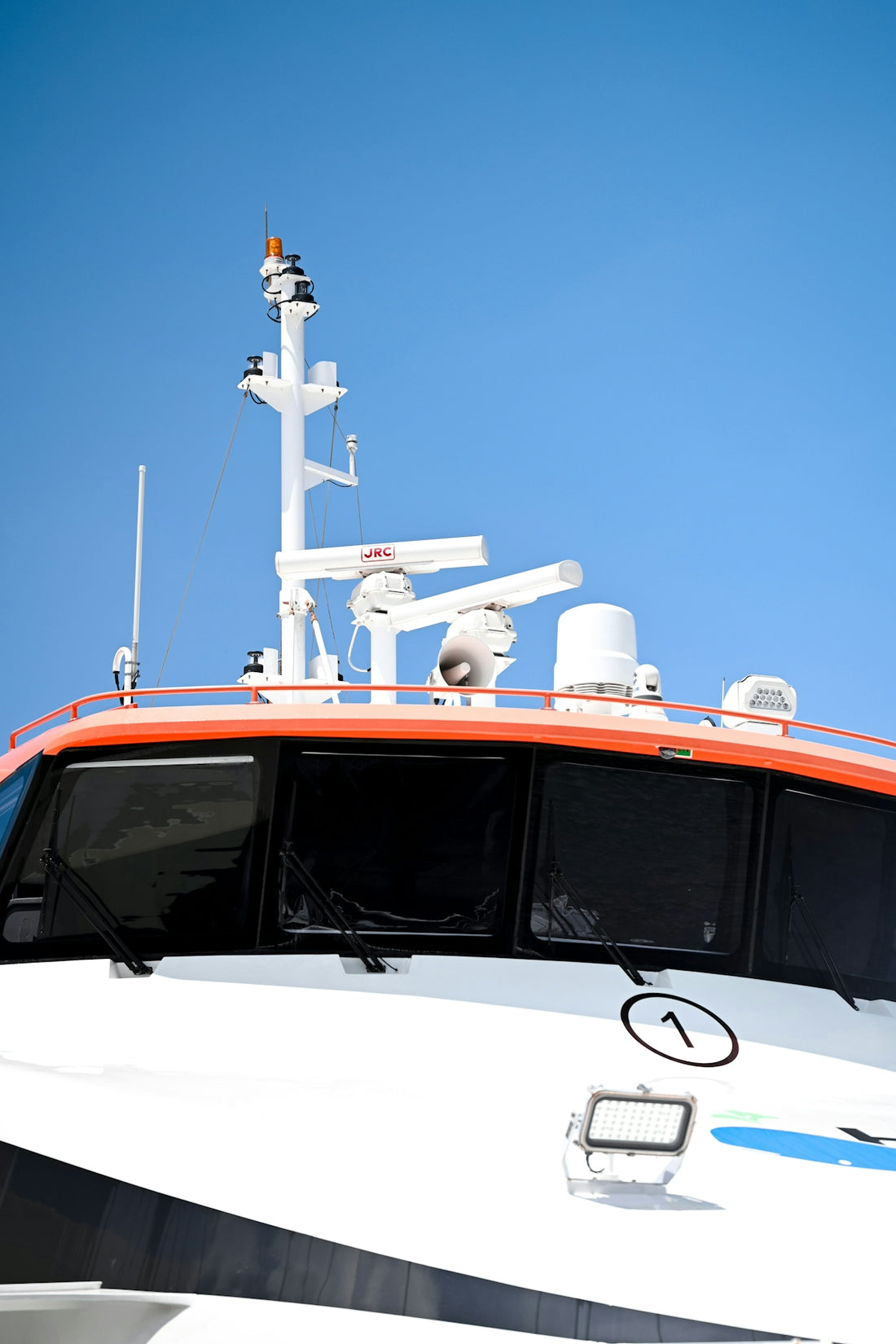 A white and black boat with a blue sky in the background