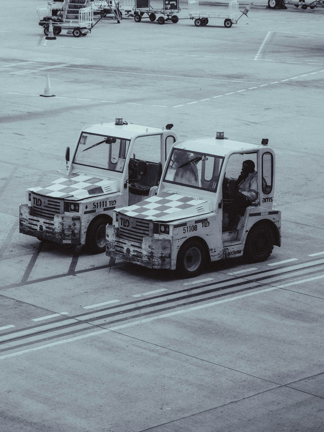Two airport tugs parked on tarmac